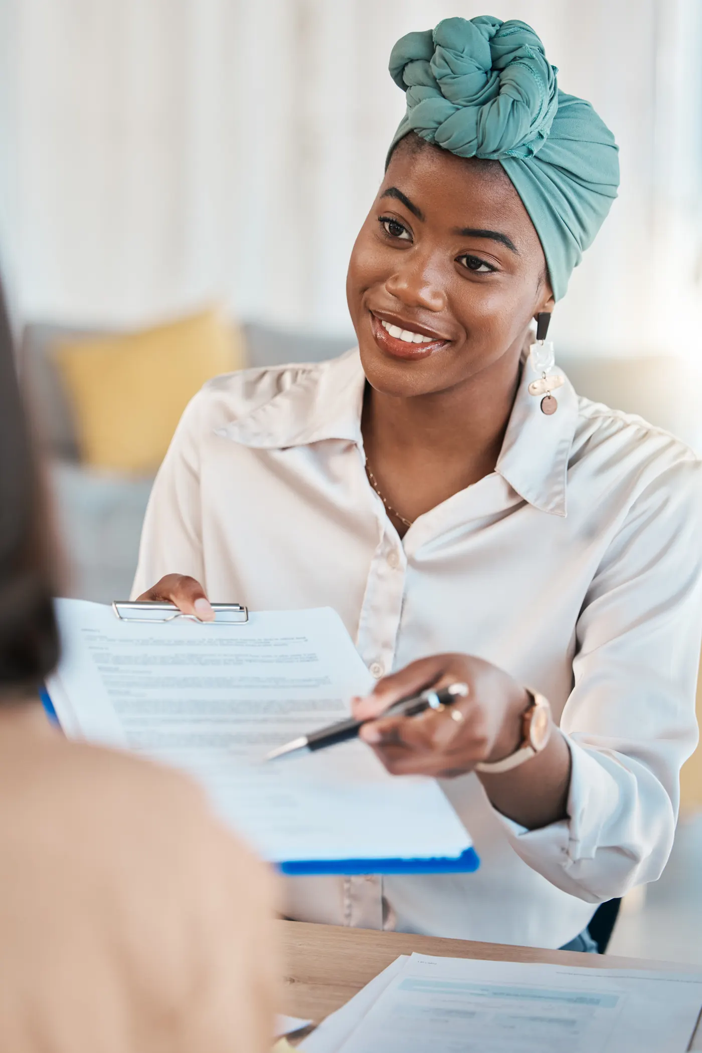 Consultant taking a client through documents at a meeting