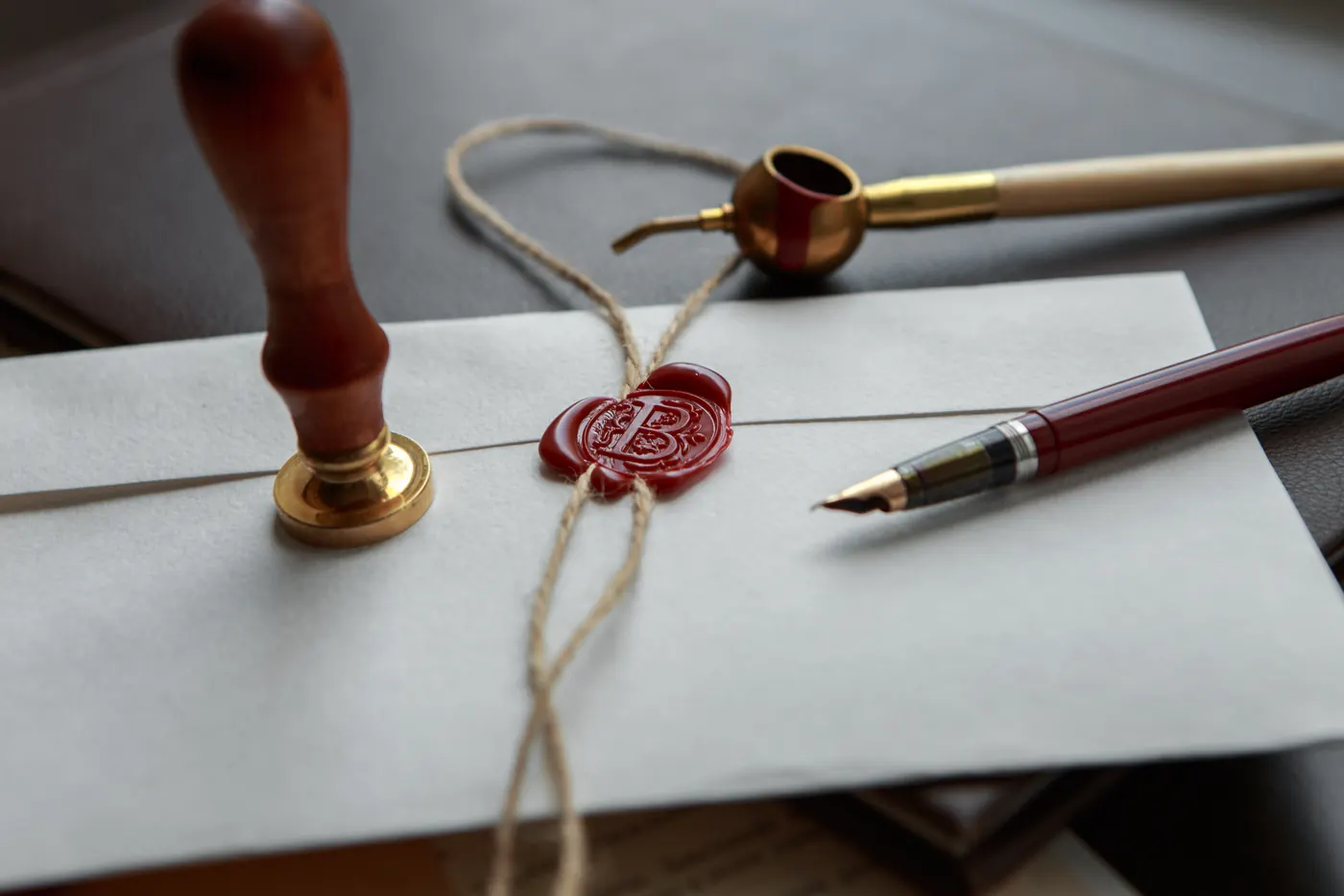 Fountain pen and old notarial wax seal on document, closeup