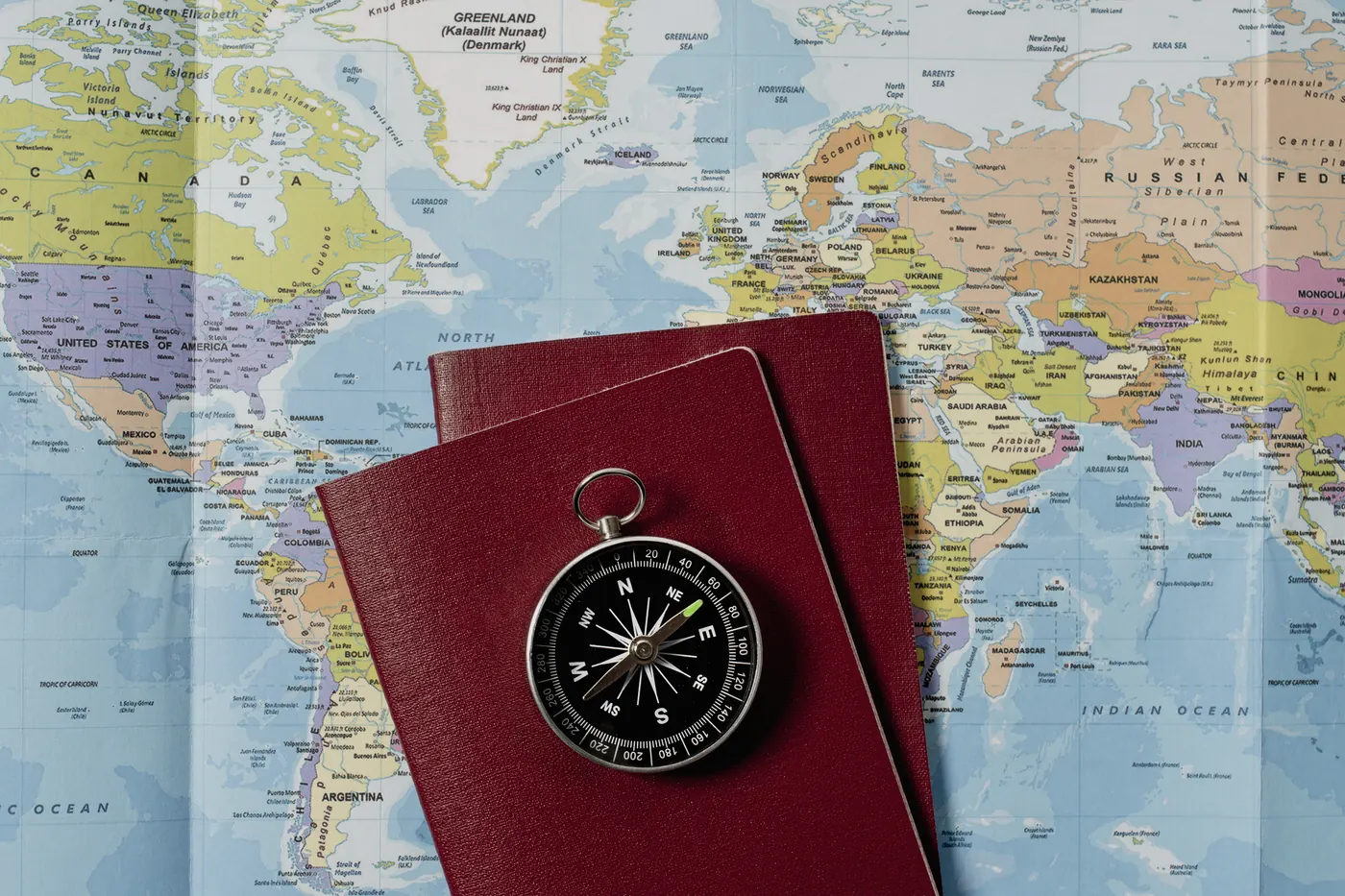 View of world travel map with passports and compass