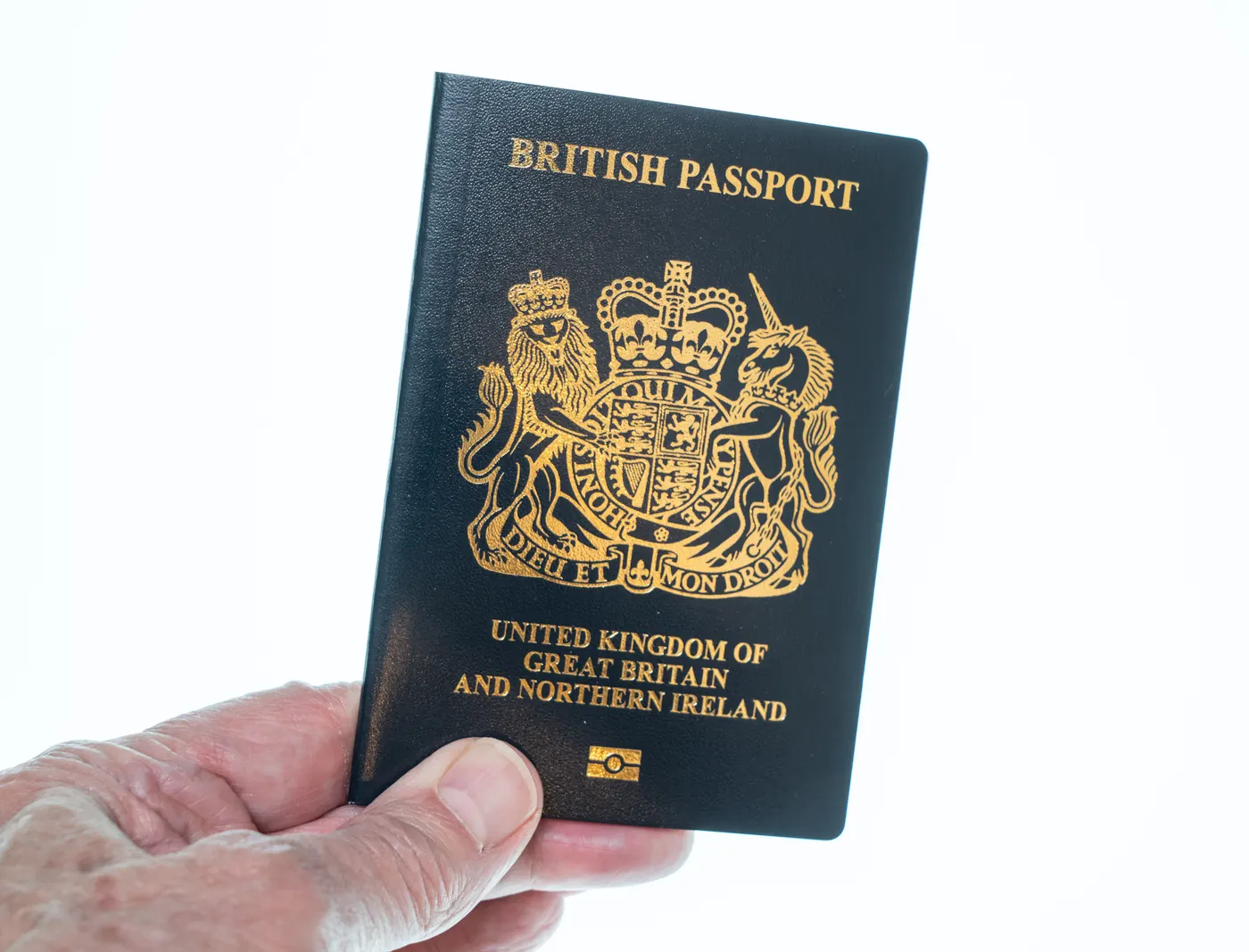 New post Brexit blue United Kingdom passport laying against a white background