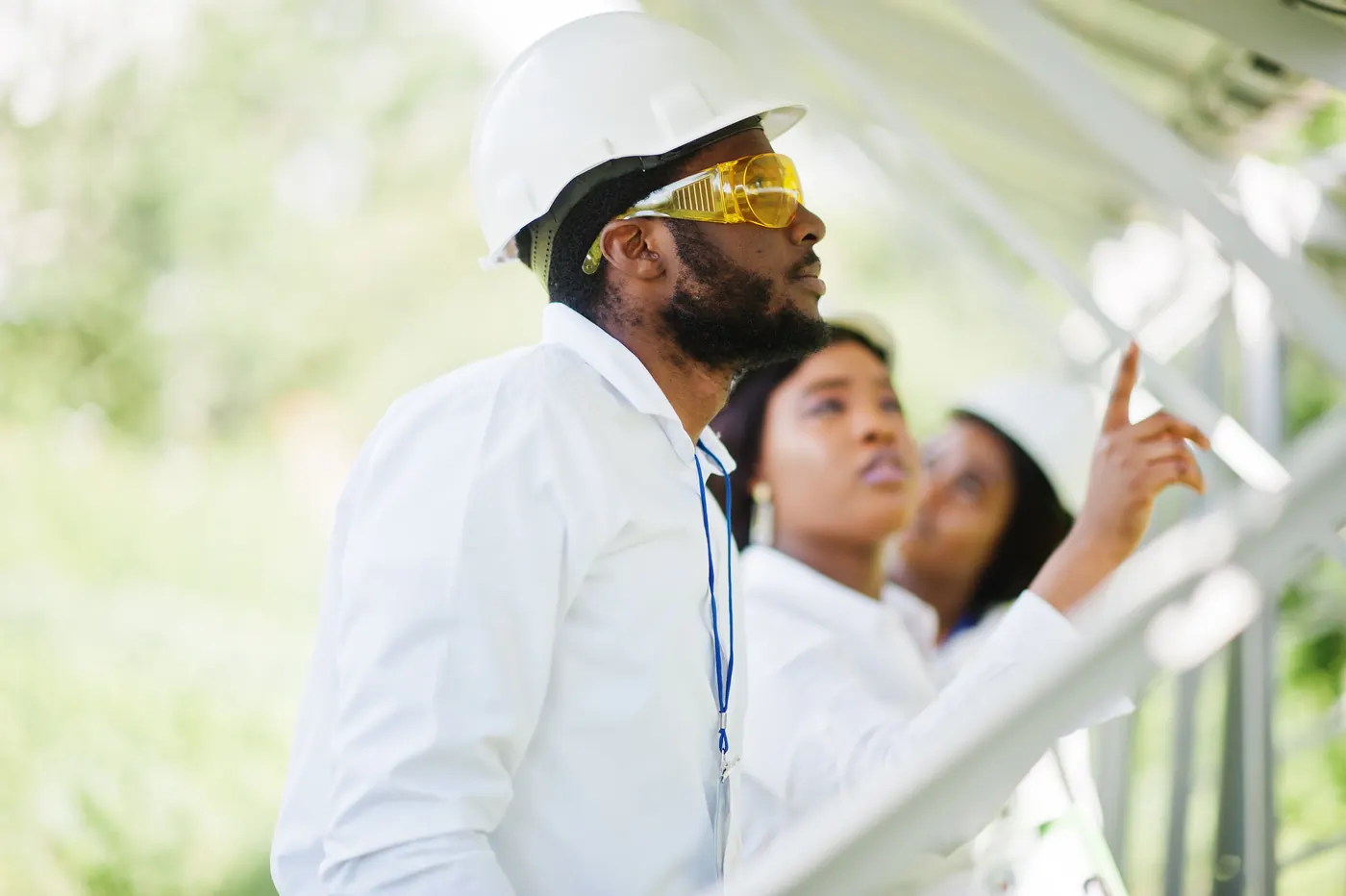Group of three black engineers meeting at solar station