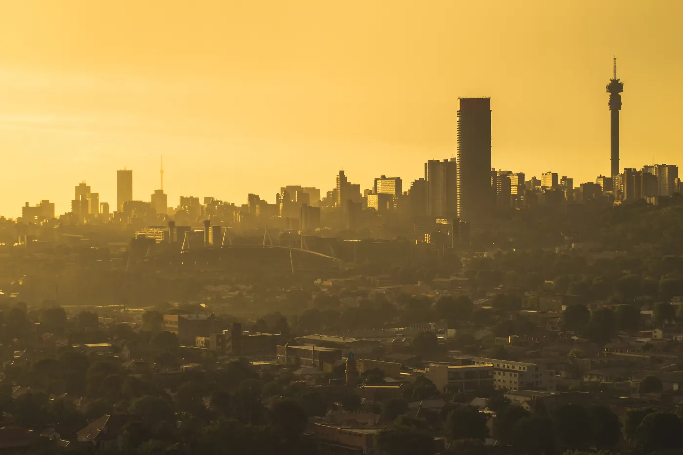 Buildings in city against sky (Johannesburg skyline, golden hour)