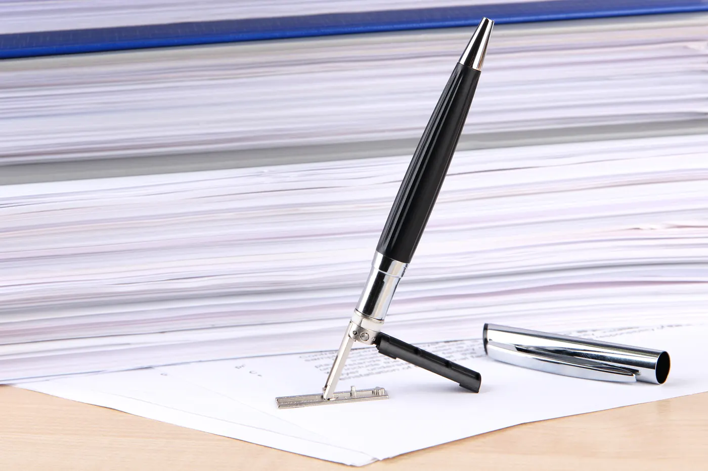Pen and official stamp on a stack of papers
