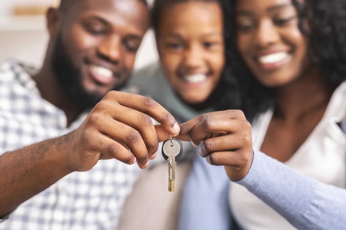 Family holding the keys to their new home