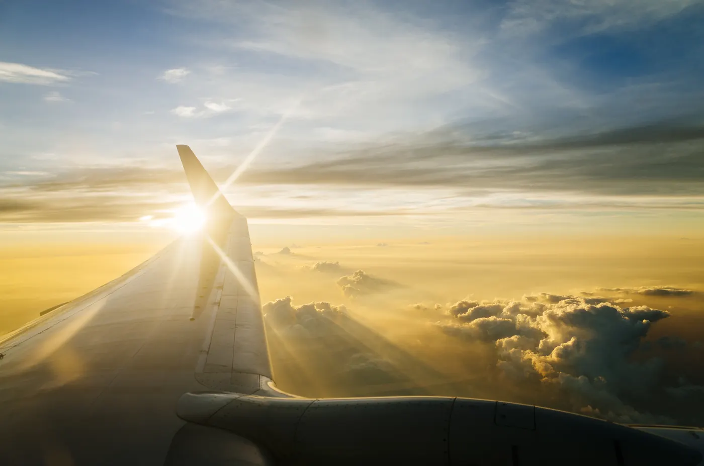 Wing of airplane in sky at twilight/sunset