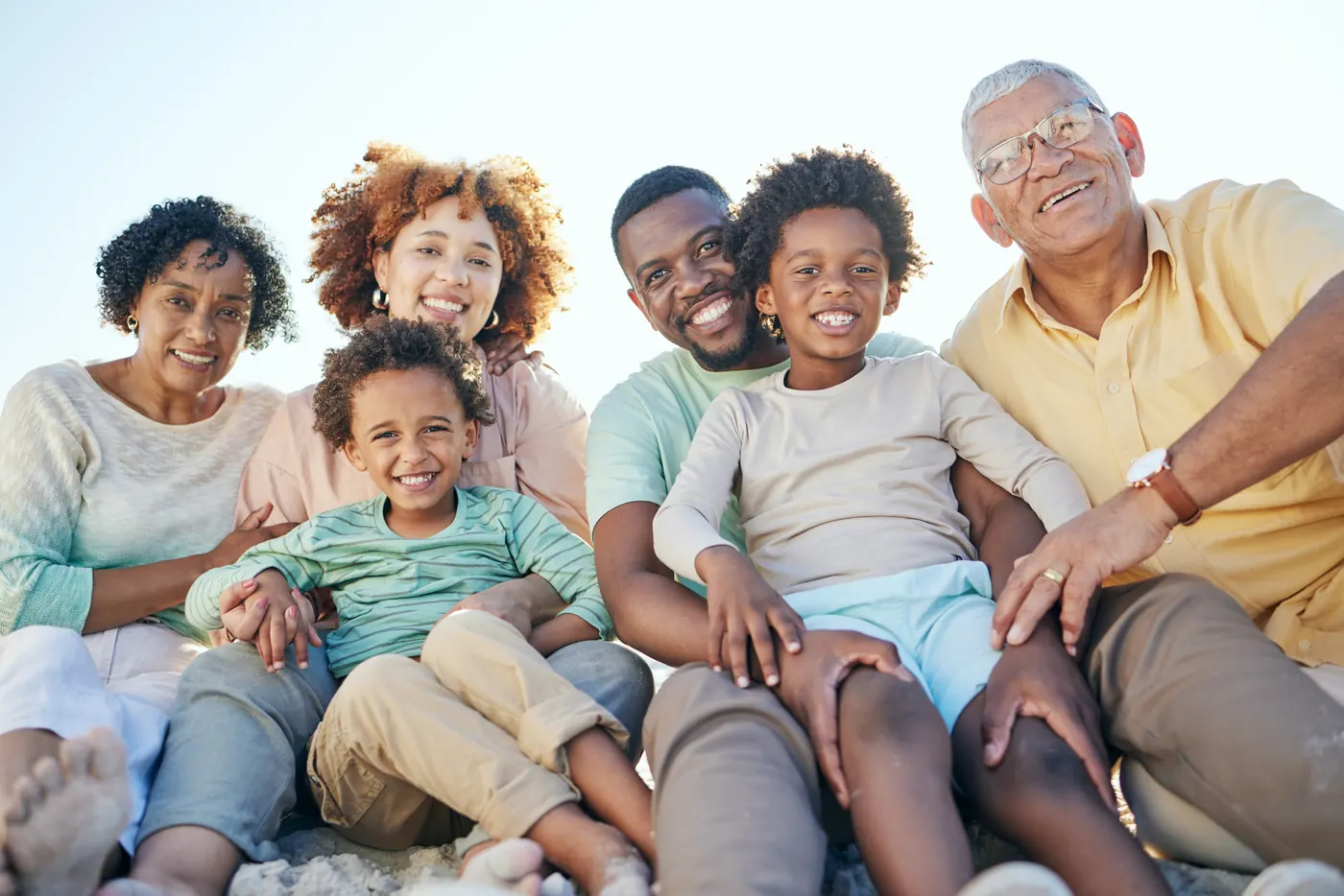 Black family with grandparents and children on the beach