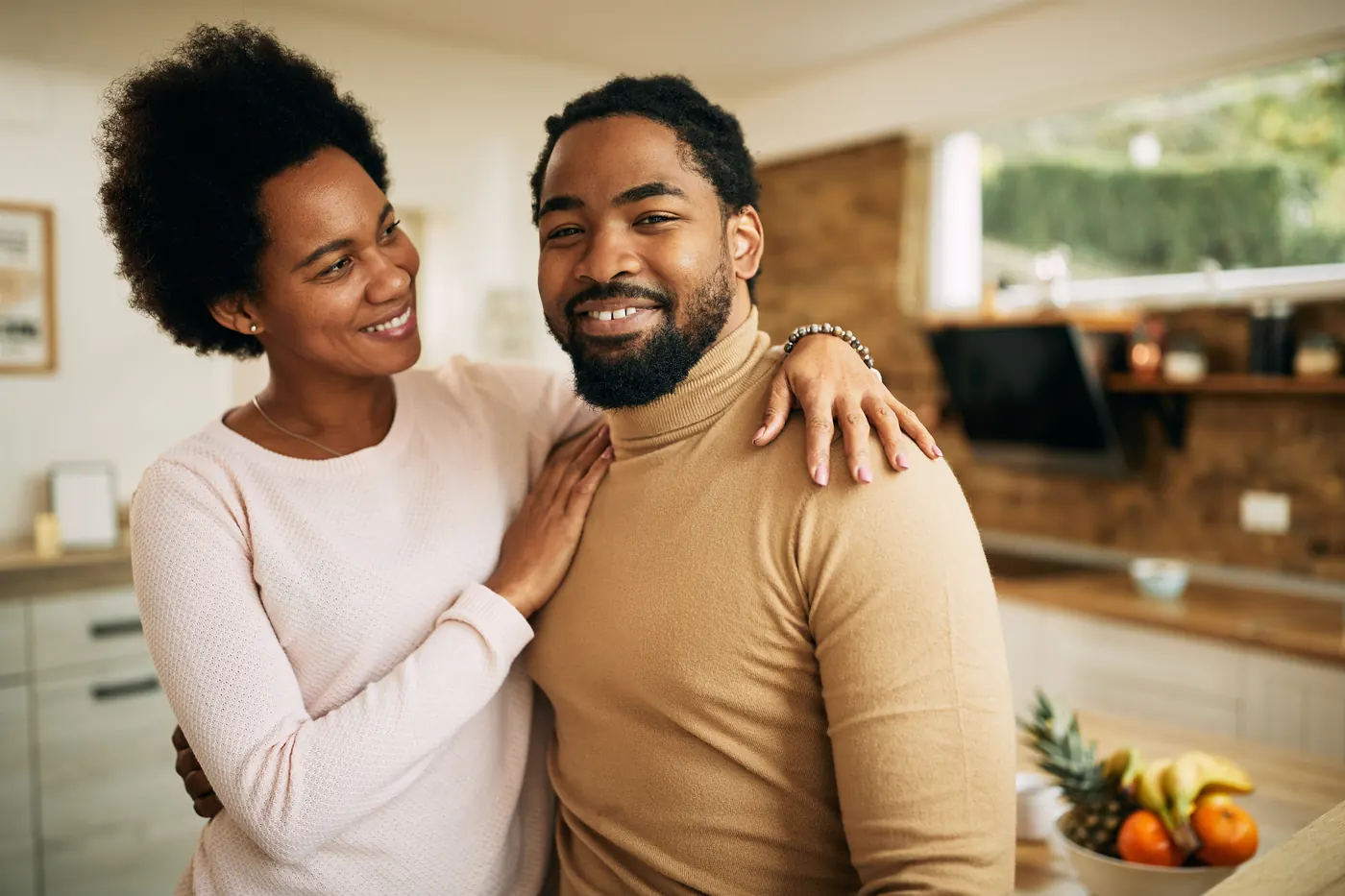 Happy African American man and his wife at home